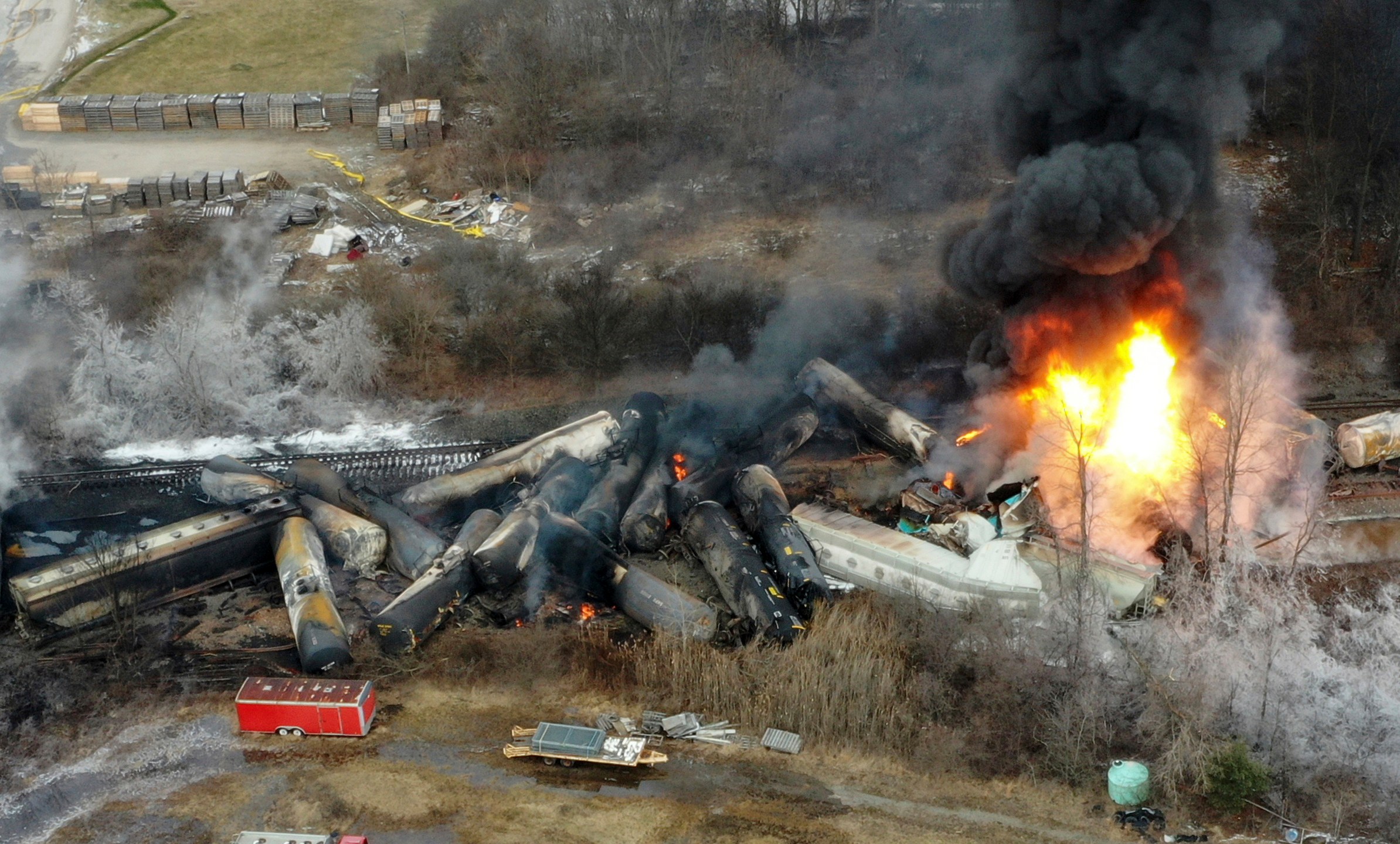 FILE - Portions of a Norfolk Southern freight train that derailed the night before burn in East Palestine, Ohio, Feb. 4, 2023. On Tuesday, April 9, 2024, Days before the National Transportation Safety Board is set to explain why first responders were wrong to blow open five tank cars and burn the toxic chemical inside after the East Palestine derailment, Norfolk Southern said Friday, June 21, 2024 it plans to lead an industrywide effort to improve the way those decisions are made. (AP Photo/Gene J. Puskar, File)