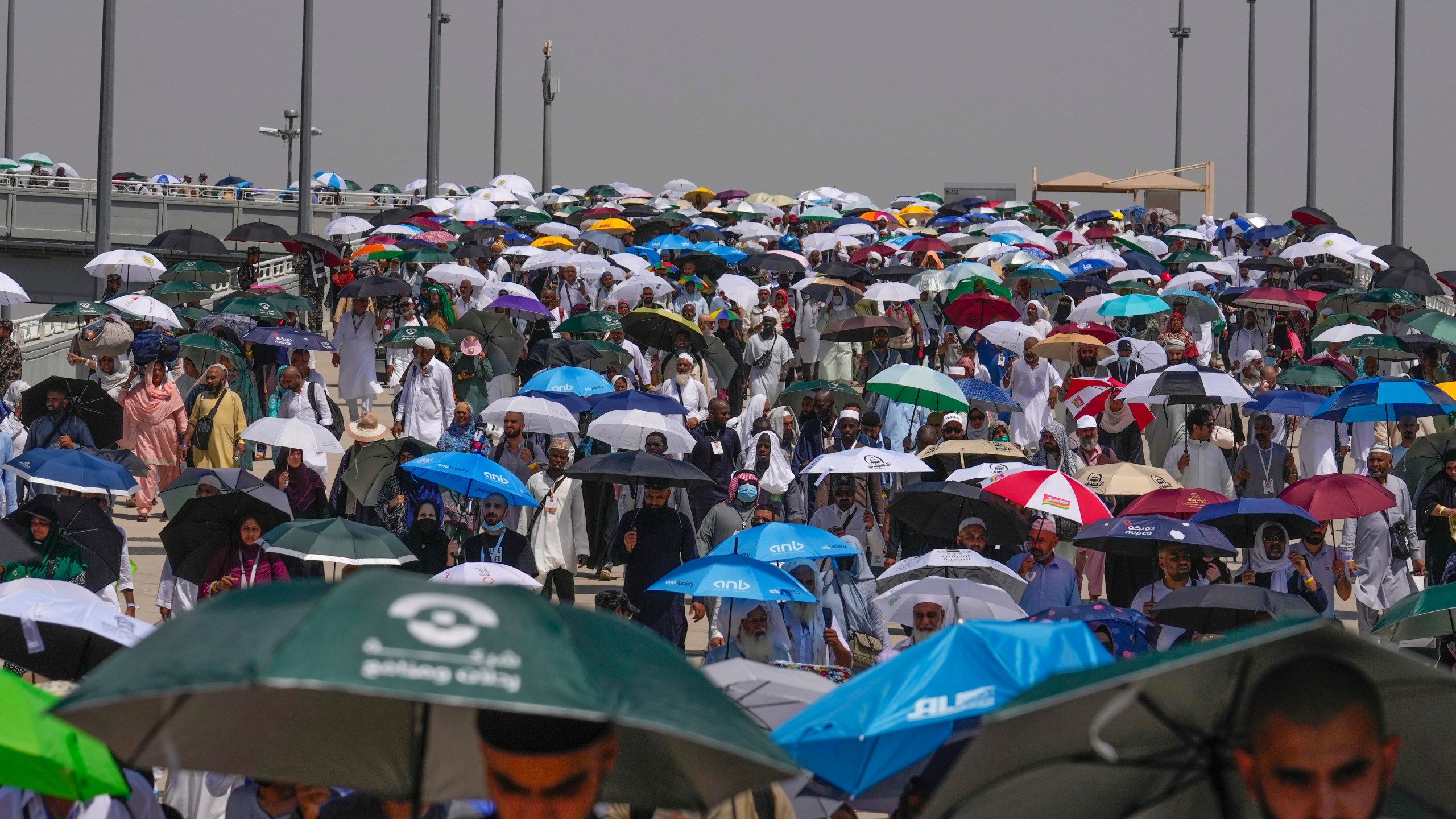 FILE - Muslim pilgrims use umbrellas to shield themselves from the sun as they arrive to cast stones at pillars in the symbolic stoning of the devil, the last rite of the annual hajj, in Mina, near the holy city of Mecca, Saudi Arabia, Tuesday, June 18, 2024. More than 1,000 people died during this year’s Hajj pilgrimage in Saudi Arabia as the faithful faced extreme high temperatures at Islamic holy sites in the desert kingdom, officials said Sunday, June 23, 2024. (AP Photo/Rafiq Maqbool)