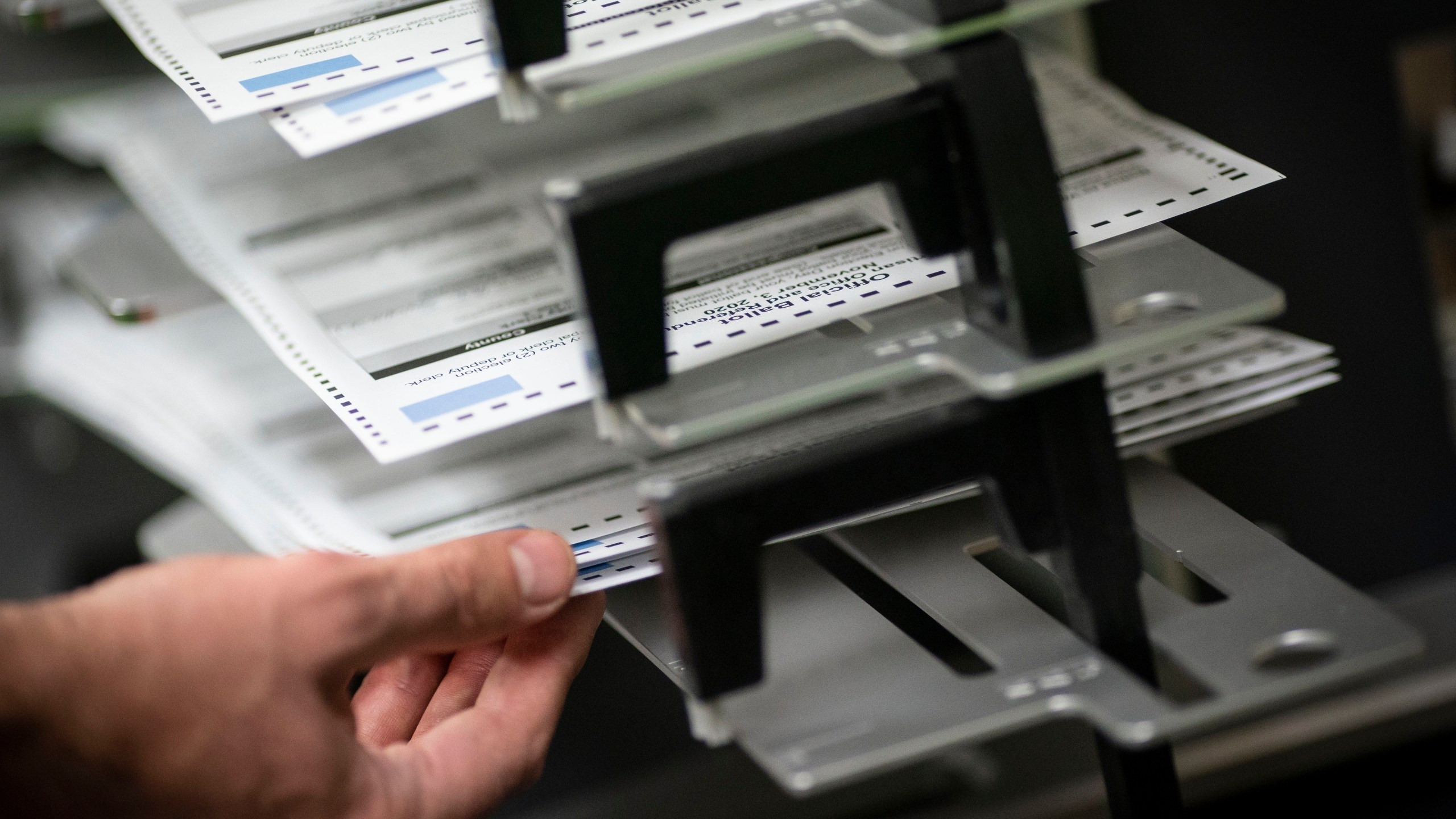 FILE - Poll workers sort out early and absentee ballots at the Kenosha Municipal Building on Election Day, Nov. 3, 2020, in Kenosha, Wis. A Wisconsin judge on Monday, June 24, 2024, is set to consider whether to allow people with disabilities to vote electronically from home in the swing state this fall. (AP Photo/Wong Maye-E, File)