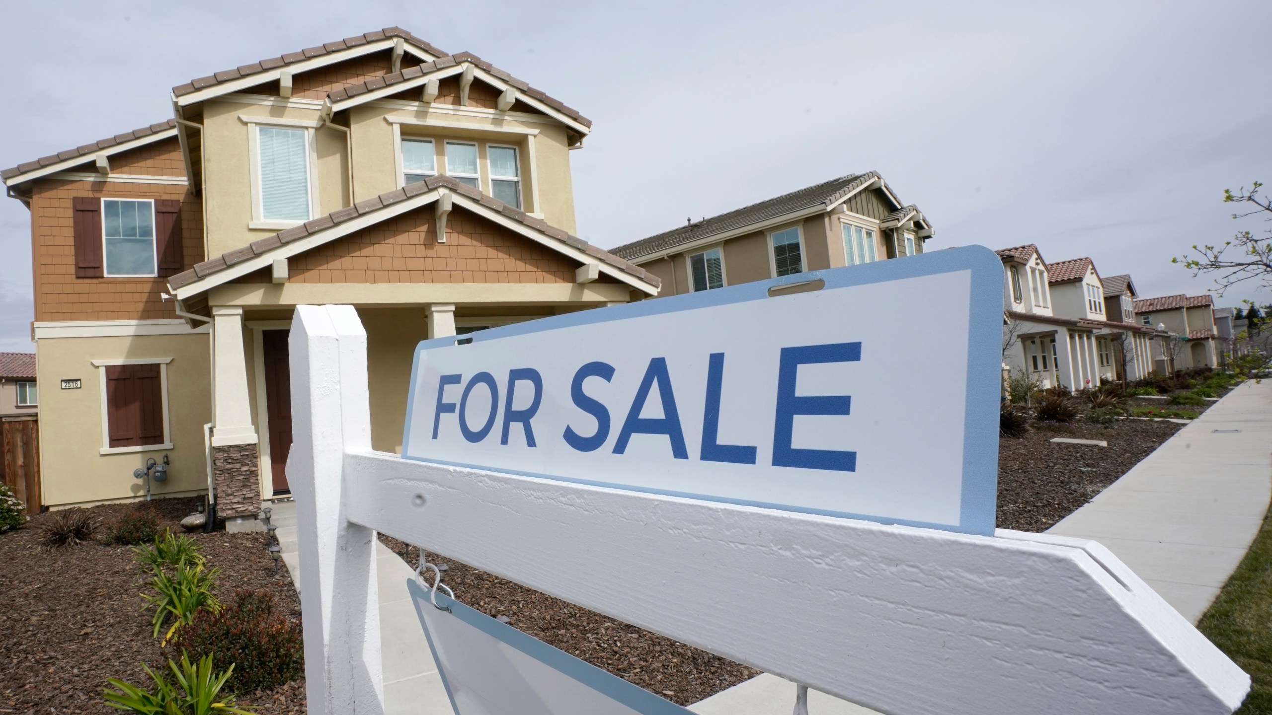 FILE - A for sale sign is posted in front of a home in Sacramento, Calif., March 3, 2022. The Biden administration is announcing new federal initiatives to increase access to affordable housing as high interest rates and still-high prices on groceries and other necessities have dramatically pushed up the cost of living in the post-pandemic years. Treasury Secretary Janet Yellen is traveling to Minneapolis on Monday, June 24, 2024, to promote the new investments. (AP Photo/Rich Pedroncelli, File)