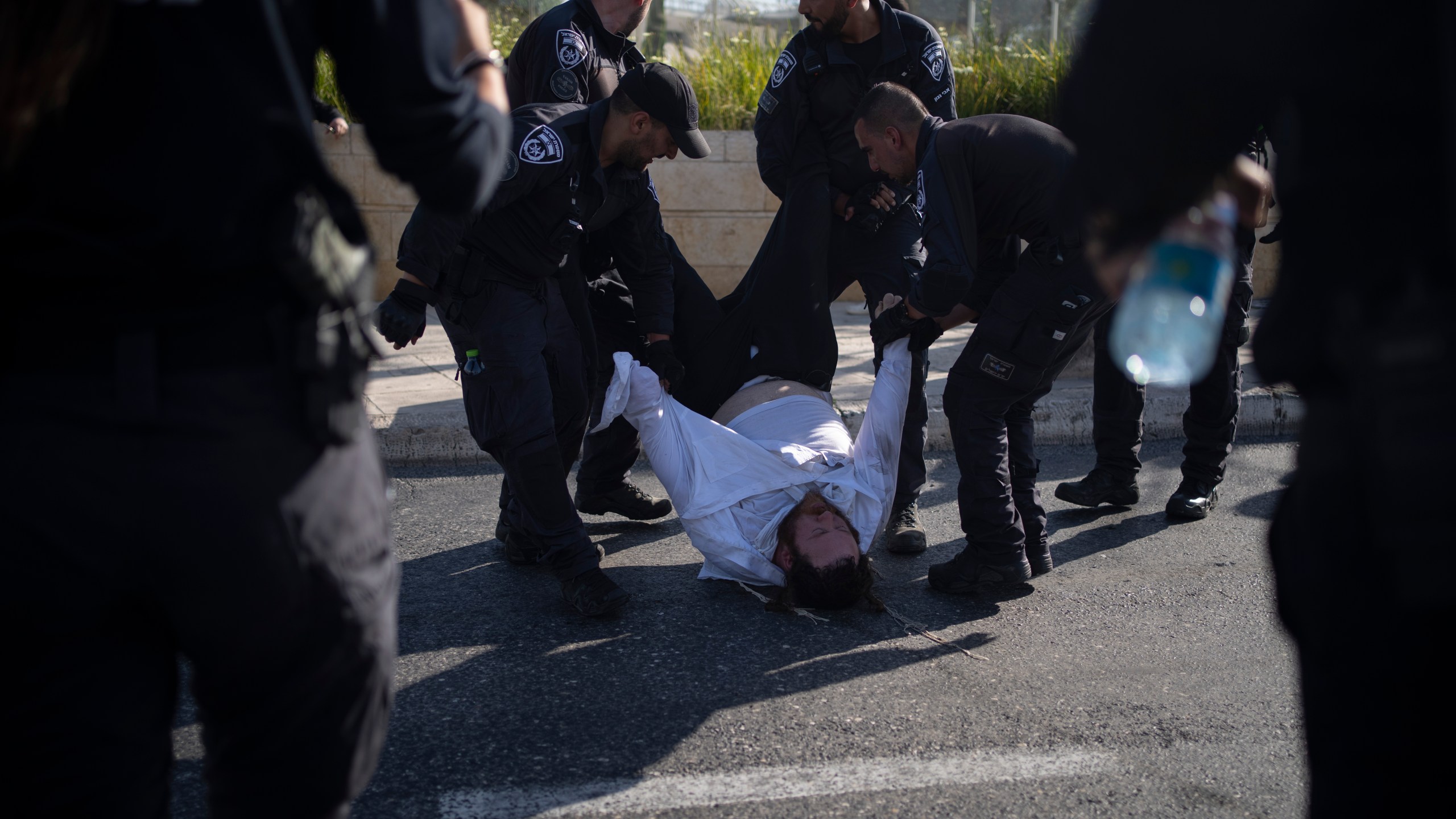 FILE - Israeli police officers remove an ultra-Orthodox Jewish man from the street during a protest against army recruitment in Jerusalem on June 2, 2024. Israel’s Supreme Court on Tuesday, June 25, ruled unanimously that the military must begin drafting ultra-Orthodox men for military service, a decision that could lead to the collapse of Prime Minister Benjamin Netanyahu’s governing coalition as Israel continues to wage war in Gaza. (AP Photo/Leo Correa, File)