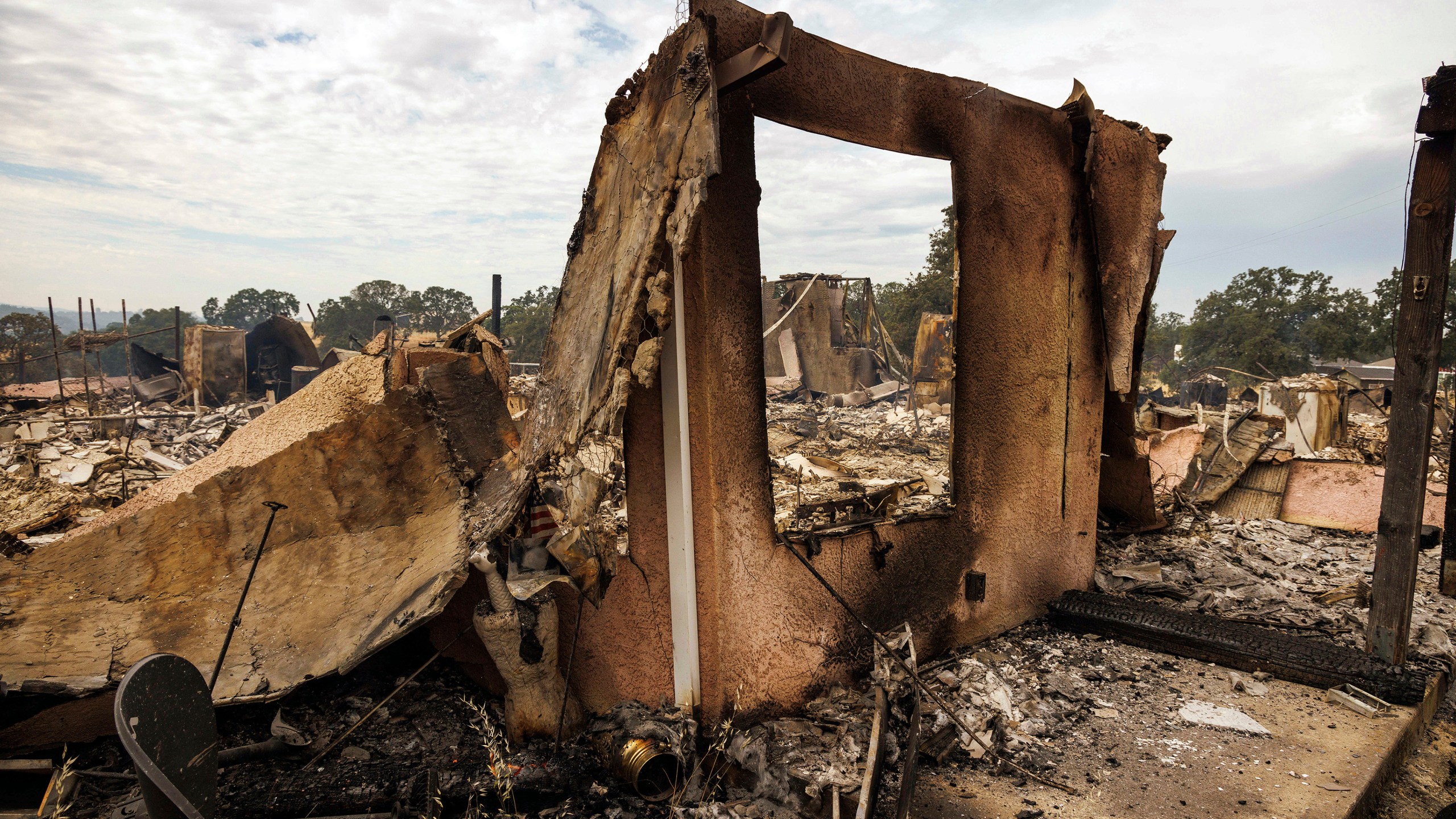 The remains of a structure destroyed by the Apache Fire as it burns in Palermo, Calif., on Tuesday, Jun. 25, 2024. According to Cal Fire, more than a dozen new fires sparked by lightning. (AP Photo/Ethan Swope)