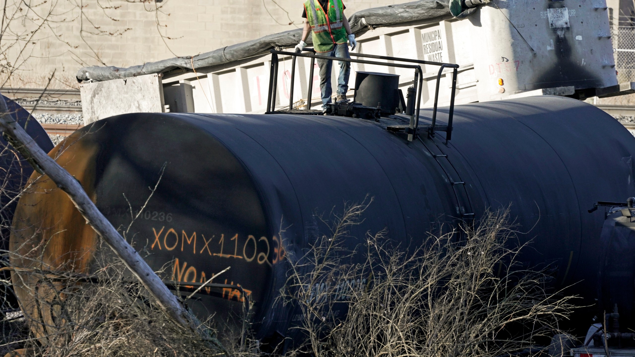 FILE - A cleanup worker stands on a derailed tank car of a Norfolk Southern freight train in East Palestine, Ohio, continues, Feb. 15, 2023. The National Transportation Safety Board’s daylong hearing on what caused the East Palestine derailment and how to prevent similar disasters gave the community, railroads and policymakers plenty to think about. (AP Photo/Gene J. Puskar, File)