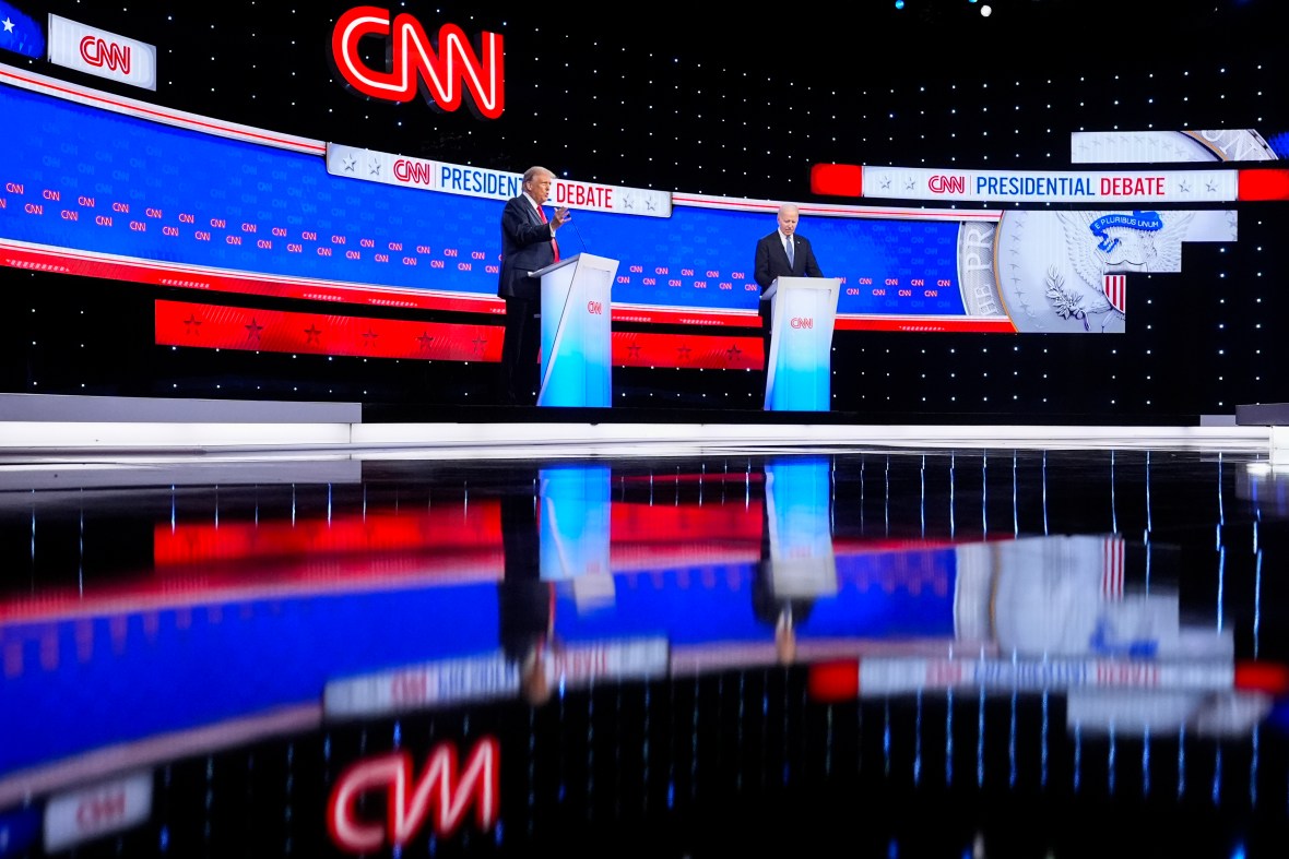 President Joe Biden, right, listens as Republican presidential candidate former President Donald Trump speaks during a presidential debate hosted by CNN, Thursday, June 27, 2024, in Atlanta. (AP Photo/Gerald Herbert)