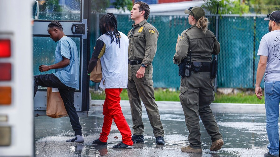 Migrants prepare to depart the U.S. Customs and Border Protection - Marathon Border Patrol Station in Marathon, Fla. on Wednesday, June 26, 2024. A group of more than 100 migrants from Haiti arrived off Key West in a sailboat early Wednesday morning, according to the Monroe County Sheriff's Office. (Al Diaz/Miami Herald via AP)