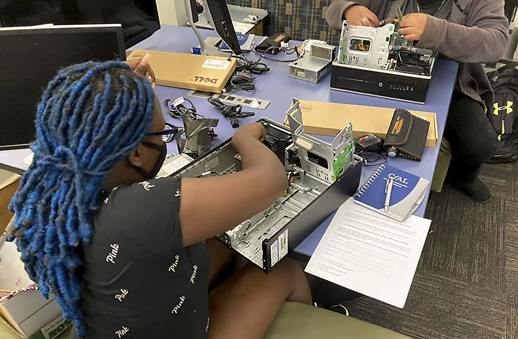 In this undated photo, a Connecticut high school student practices skills she has learned in the Building Your Own Computer program offered by the Connecticut-based group CfAL for Digital Inclusion. States are looking to beef up their residents tech skills as generative artificial intelligence plays a greater role in the workplace. CfAL officials, however, say basic computer skills are also still needed. (Rose Servetnick/CfAL for Digital Inclusion via AP)