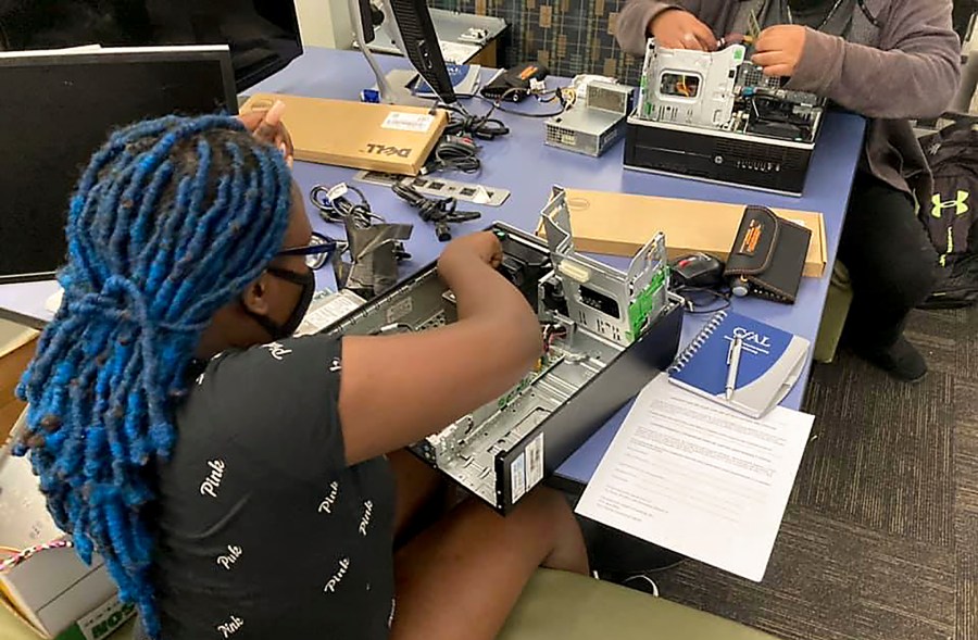 In this undated photo, a Connecticut high school student practices skills she has learned in the Building Your Own Computer program offered by the Connecticut-based group CfAL for Digital Inclusion. States are looking to beef up their residents tech skills as generative artificial intelligence plays a greater role in the workplace. CfAL officials, however, say basic computer skills are also still needed. (Rose Servetnick/CfAL for Digital Inclusion via AP)