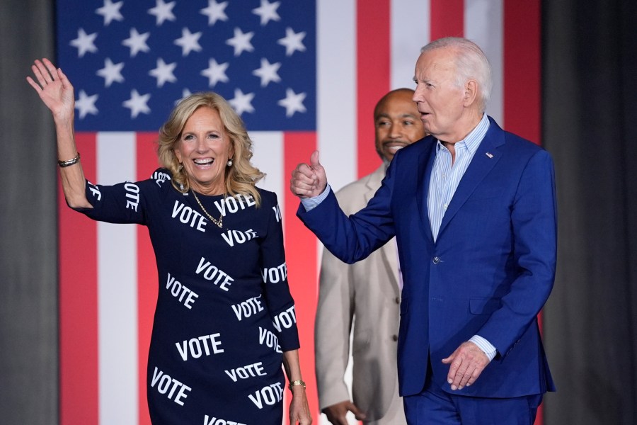 President Joe Biden, right, and first lady Jill Biden, left, walk to the stage to speak at a campaign rally, joined in background by Eric Fitts, Friday, June 28, 2024, in Raleigh, N.C. (AP Photo/Evan Vucci)