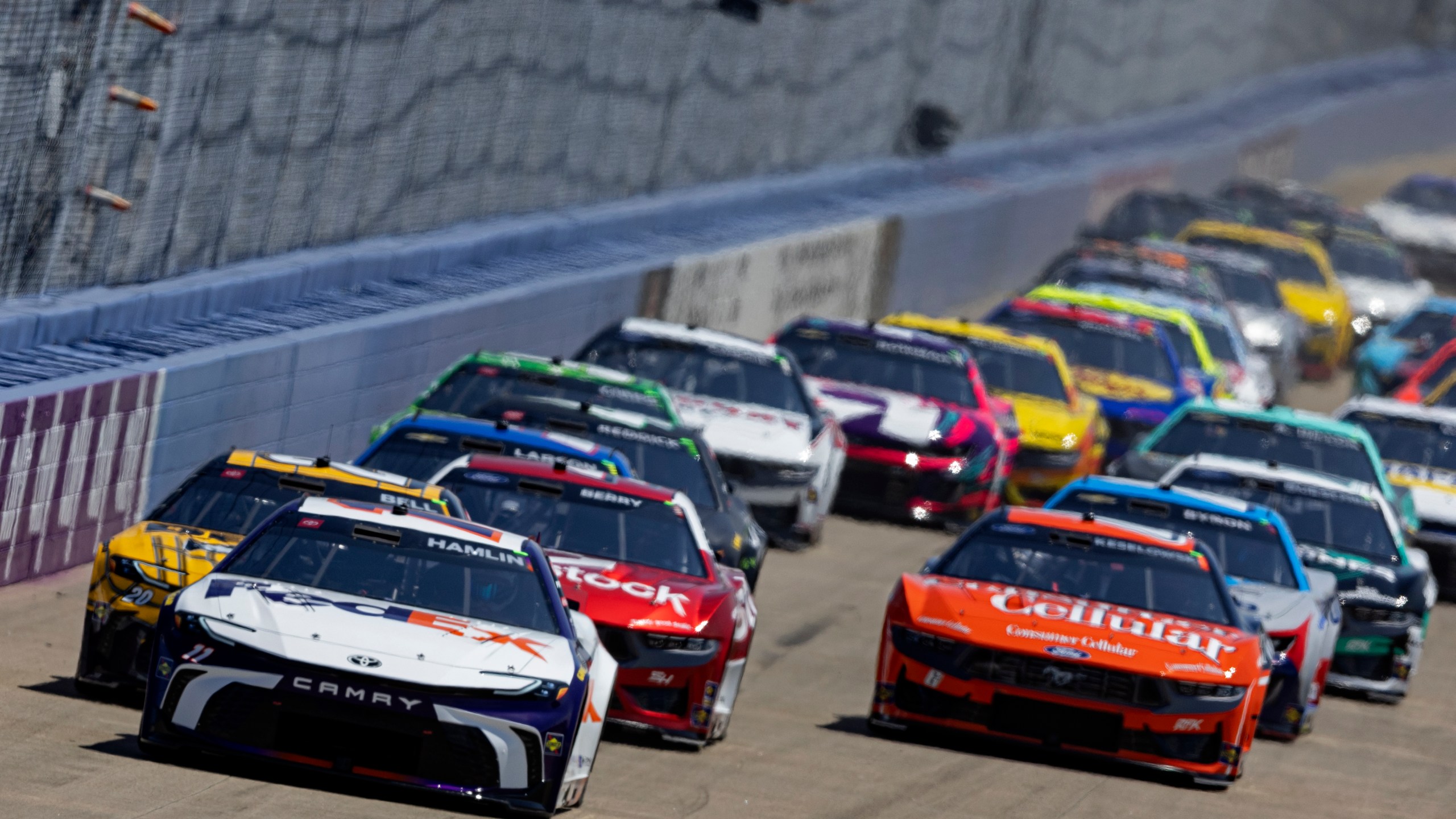 Denny Hamlin (11) leads the field to start a NASCAR Cup Series auto race, Sunday, June 30, 2024, in Gladeville, Tenn. (AP Photo/Wade Payne)