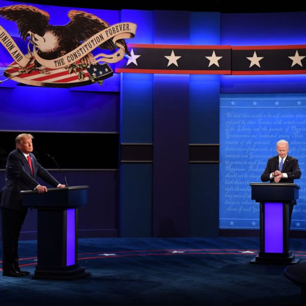 Trump and Biden stand at podiums on different sides of the stage.