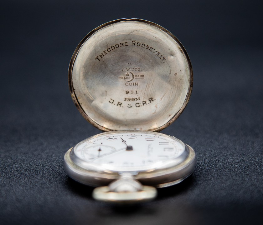 The front cover of President Theodore Roosevelt's watch, a Waltham 17 jewel watch with an inexpensive coin silver case. Engraved is the message: "From J.R. and C.R.R."