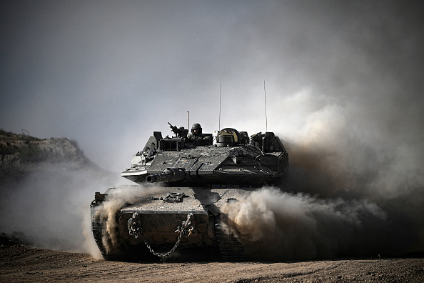 An Israeli army battle tank moves in an area along the border with the Gaza Strip and southern Israel