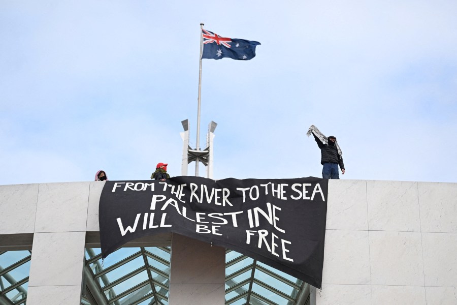 Pro-Palestinian protesters hang banners from the top of Parliament House in Canberra, Australia, July 4, 2024.