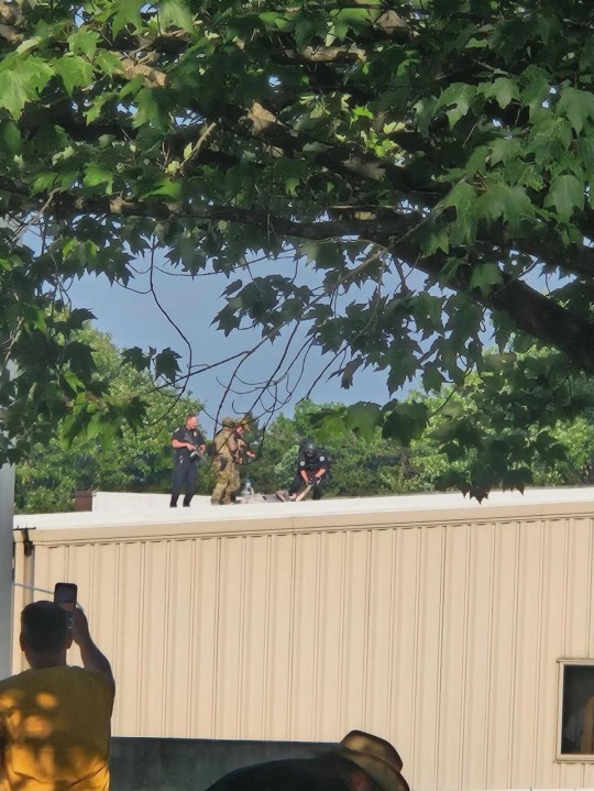 Secret Service agents on a roof appear to be restraining the suspected shooter who fired shots at former President Donald Trump's rally in Pennsylvania. Credit: NewsNation Source