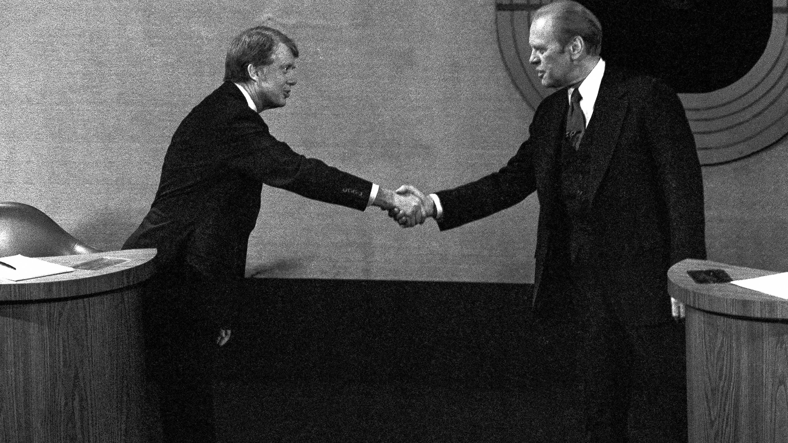 FILE - Jimmy Carter, left, and Gerald Ford, right, shake hands before the third presidential debate, Oct. 22, 1976, in Williamsburg, Va. (AP Photo/File)