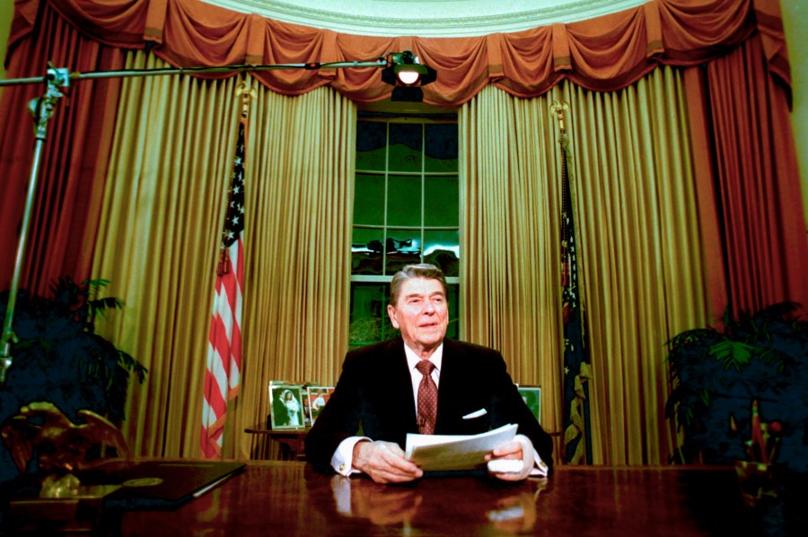 FILE - President Ronald Reagan sits in the Oval Office after he delivered his farewell address to the nation Jan. 11, 1989, from the Oval Office of the White House in Washington. The age question for presidential candidates is more than four decades old. (AP Photo/Ron Edmonds, File)