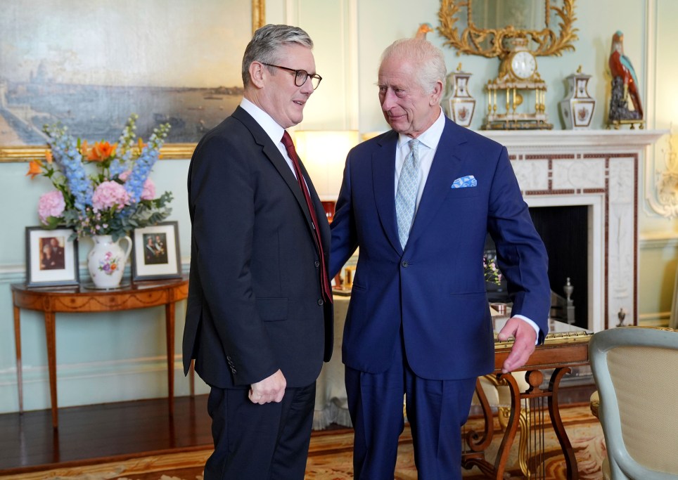 Britain's King Charles III, right, speaks with Keir Starmer where he invited the Labour Party leader to become prime minister and to form a new government, following the landslide general election victory for the Labour Party, in London, Friday, July 5, 2024. (Yui Mok, Pool Photo via AP)