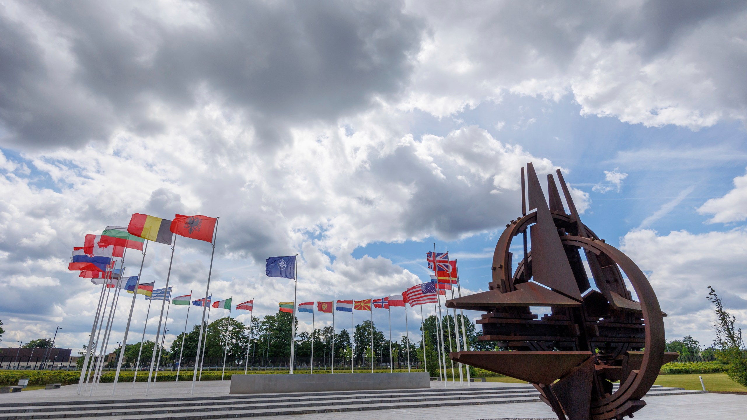 FILE - Flags of NATO member countries flap in the wind outside NATO headquarters, in Brussels, Wednesday, May 25, 2022. United States President Joe Biden and his counterparts meet in Washington for a three-day summit beginning Tuesday, July 9, 2024 to mark the military alliance's 75th anniversary, with Russian troops pressing their advantave along Ukraine's eastern front in the third year of war. (AP Photo/Olivier Matthys, File)