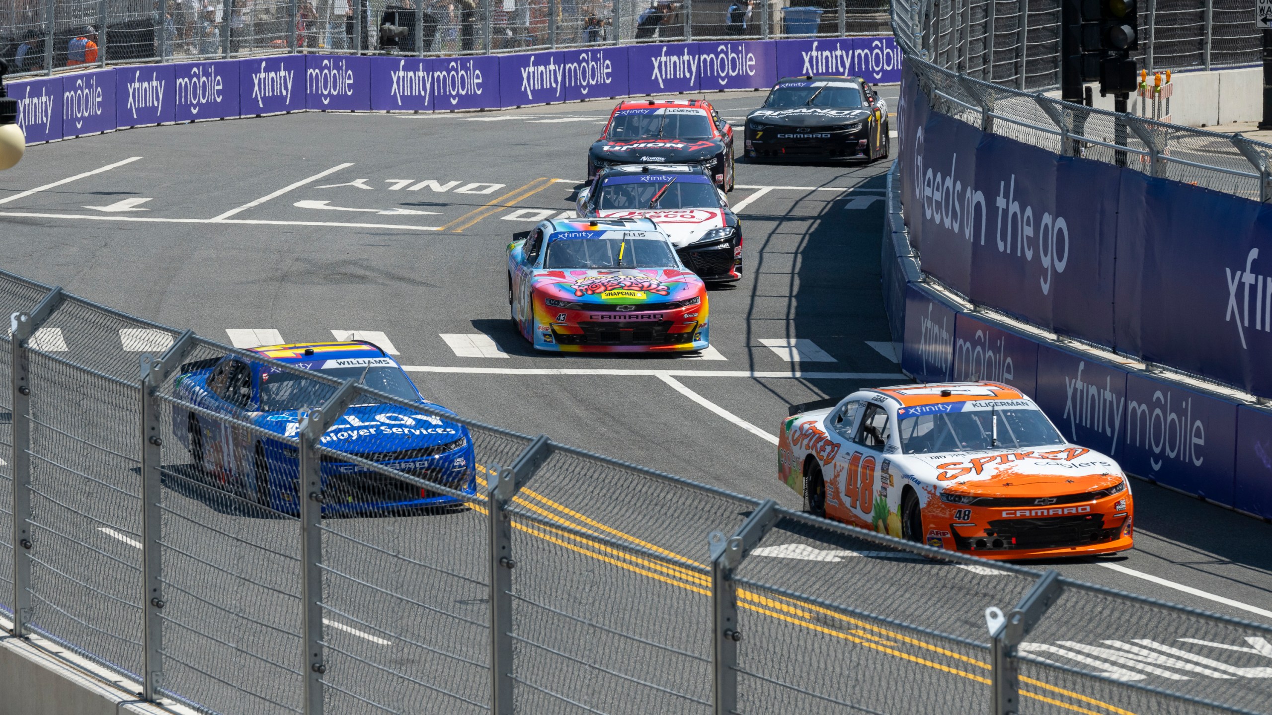 Cars navigate turn 19 during a NASCAR Xfinity Series street course auto race in Grant Park, Saturday, July 6, 202 4 in Chicago. (Tyler Pasciak LaRiviere/Chicago Sun-Times via AP)