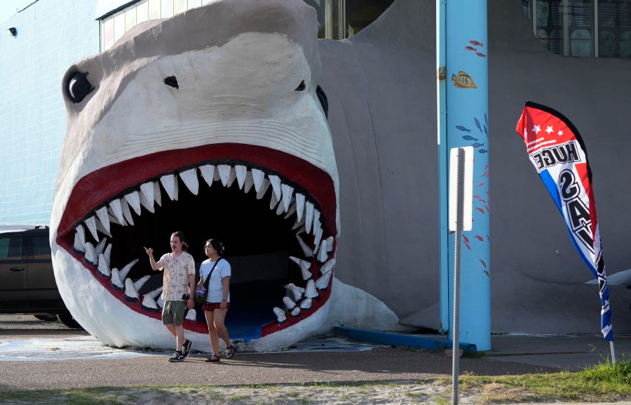 Shoppers exit a souvenir shop as Beryl advances towards the Texas coast, Saturday, July 6, 2024, in Port Aransas, Texas. (AP Photo/Eric Gay)