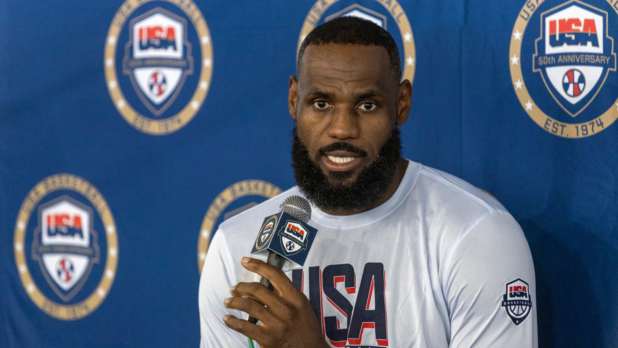 LeBron James, of the Los Angeles Lakers, responds to a question from a reporter during training camp for the United States men's basketball team Saturday, July 6, 2024, in Las Vegas. (AP Photo/Steve Marcus)