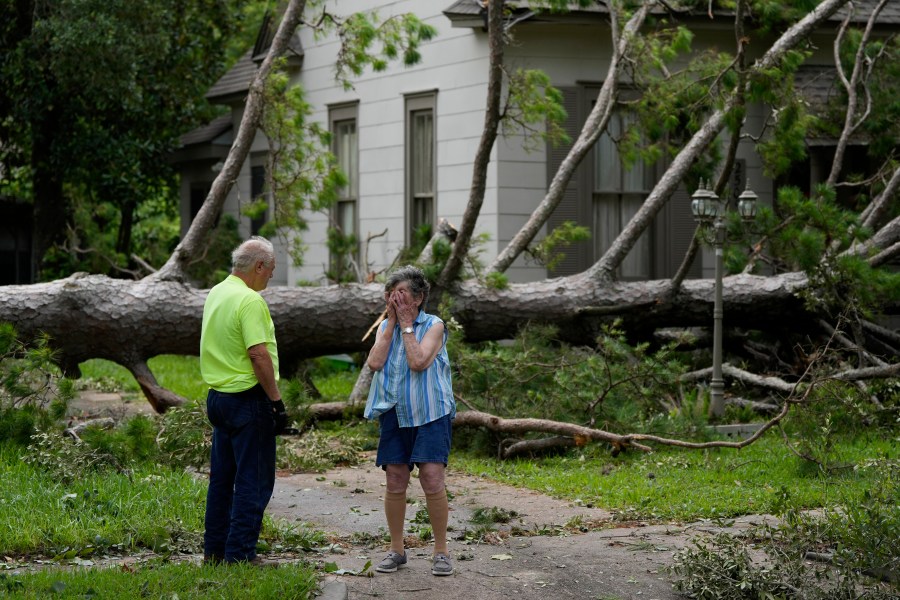 Jackie Jecmenek, right, talks with city worker Bobby Head as she stands in front of her neighbor's home after Beryl passed, Monday, July 8, 2024, in Bay City, Texas. (AP Photo/Eric Gay)