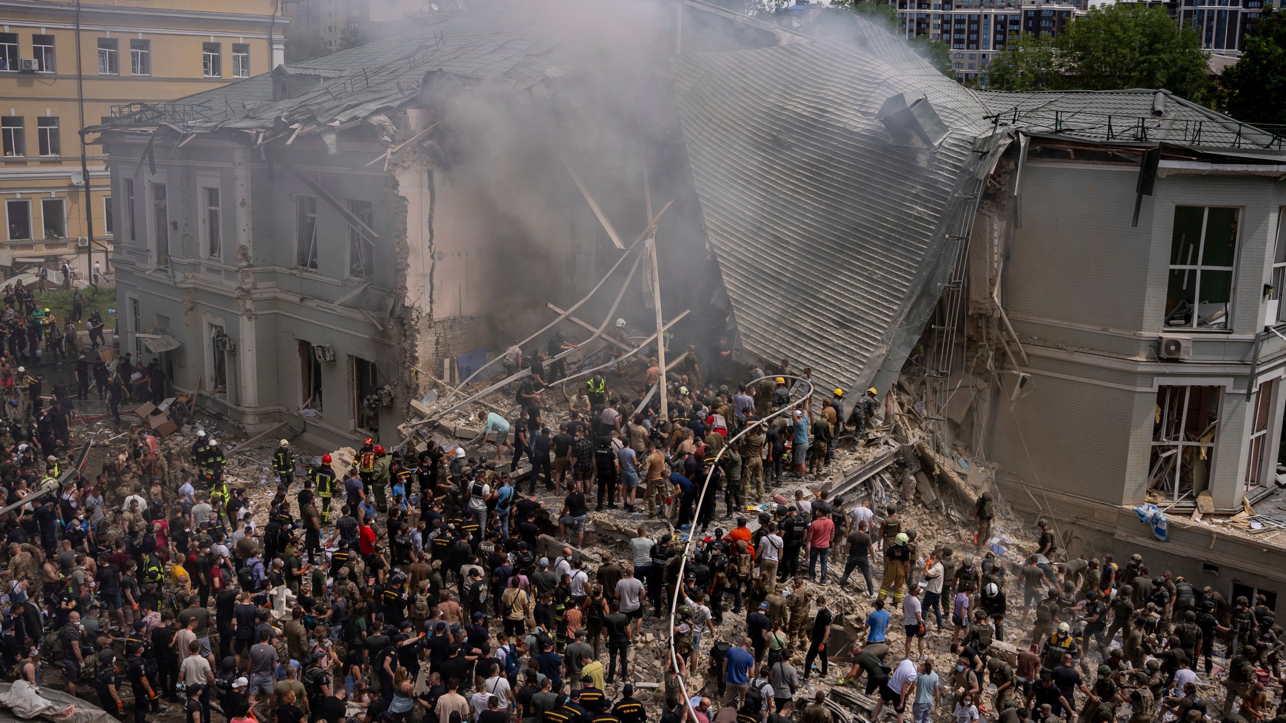 Emergency workers respond at the Okhmatdyt children's hospital hit by Russian missiles, in Kyiv, Ukraine, Monday, July 8, 2024. A major Russian missile attack across Ukraine on Monday killed at least 31 people and injured 154, officials said, with one striking a large children’s hospital in the capital of Kyiv, where emergency crews searched the rubble for victims. (AP Photo/Alex Babenko)