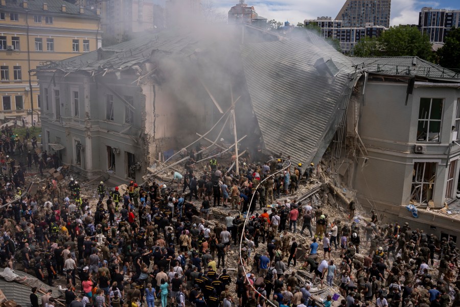 Emergency workers respond at the Okhmatdyt children's hospital hit by Russian missiles, in Kyiv, Ukraine, Monday, July 8, 2024. A major Russian missile attack across Ukraine on Monday killed at least 31 people and injured 154, officials said, with one striking a large children’s hospital in the capital of Kyiv, where emergency crews searched the rubble for victims. (AP Photo/Alex Babenko)