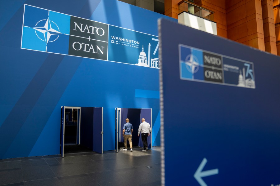 People walk inside of the Walter E. Washington Convention Center, which has been decorated with signage in preparation for the NATO Summit, Monday, July 8, 2024. New Zealand, Japan, South Korea and Australia are sending leaders or their deputies to the NATO summit in Washington this week as the military alliance shows growing interest beyond Europe and the Western Hemisphere. (AP Photo/Jacquelyn Martin)