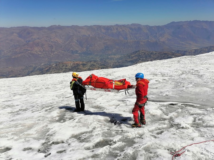 This photo distributed by the Peruvian National Police shows police carrying a body that they identify as U.S. mountain climber William Stampfl, on Huascaran mountain in Huaraz, Peru, July 5, 2024. Peruvian authorities announced on Tuesday, July 9, 2024, that they have found the mummified body of the American man who died 22 years ago, along with two other American climbers, after the three were trapped in an avalanche while trying to climb Peru's highest mountain. (Peruvian National Police via AP)