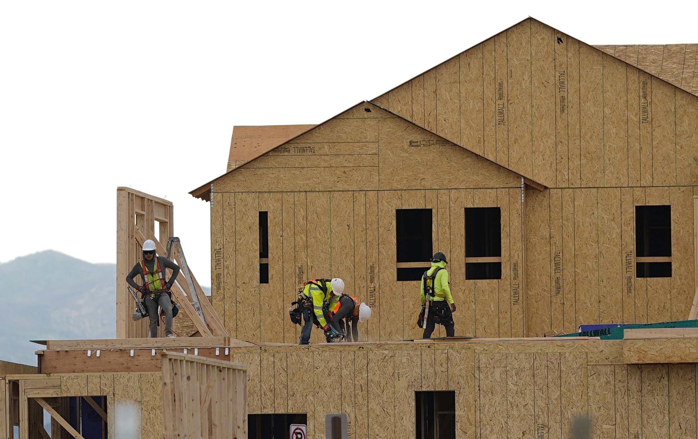 Workers construct new homes in a development.