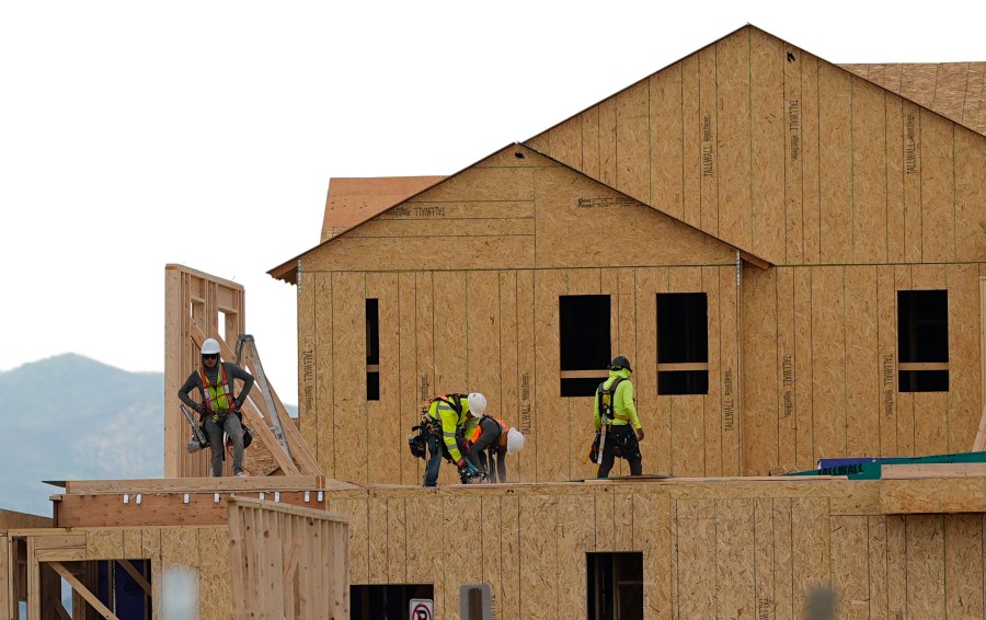 Workers construct new homes in a development.