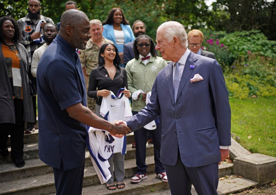 King Charles III meets Idris Elba, left, and young people attend an event for The King's Trust to discuss youth opportunity, at St James's Palace in central London, Friday July 12, 2024. The King and Mr Elba, an alumnus of The King's Trust (formerly known as The Prince's Trust), are meeting about the charity's ongoing work to support young people, and creating positive opportunities and initiatives which might help address youth violence in the UK, as well as the collaboration in Sierra Leone between the Prince's Trust International and the Elba Hope Foundation. (Yui Mok/pool photo via AP)