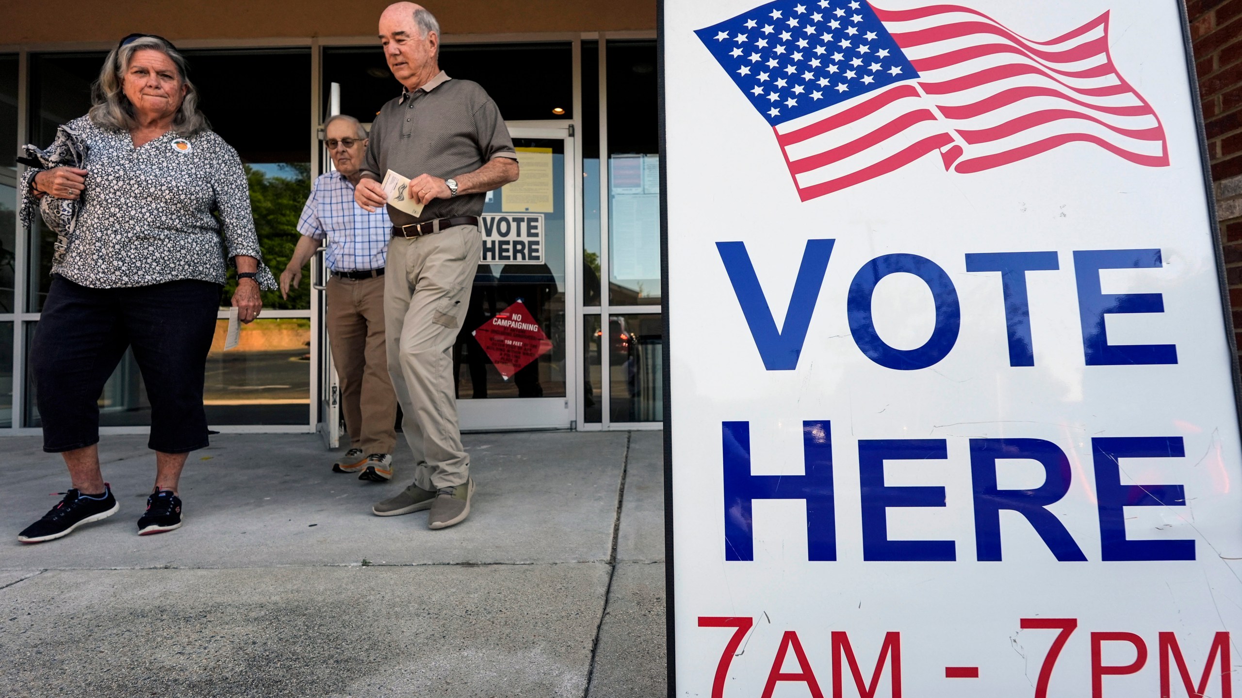 FILE - Voters depart an election center during primary voting, May 21, 2024, in Kennesaw, Ga. Conservative groups are systematically attempting to challenge large numbers of voter registrations across the country ahead of this year's presidential election. The strategy is part of a wider effort to raise questions about the integrity of this year's election as former President Donald Trump repeatedly claims without evidence that his opponents are trying to cheat. (AP Photo/Mike Stewart, File)