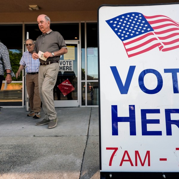 FILE - Voters depart an election center during primary voting, May 21, 2024, in Kennesaw, Ga. Conservative groups are systematically attempting to challenge large numbers of voter registrations across the country ahead of this year's presidential election. The strategy is part of a wider effort to raise questions about the integrity of this year's election as former President Donald Trump repeatedly claims without evidence that his opponents are trying to cheat. (AP Photo/Mike Stewart, File)