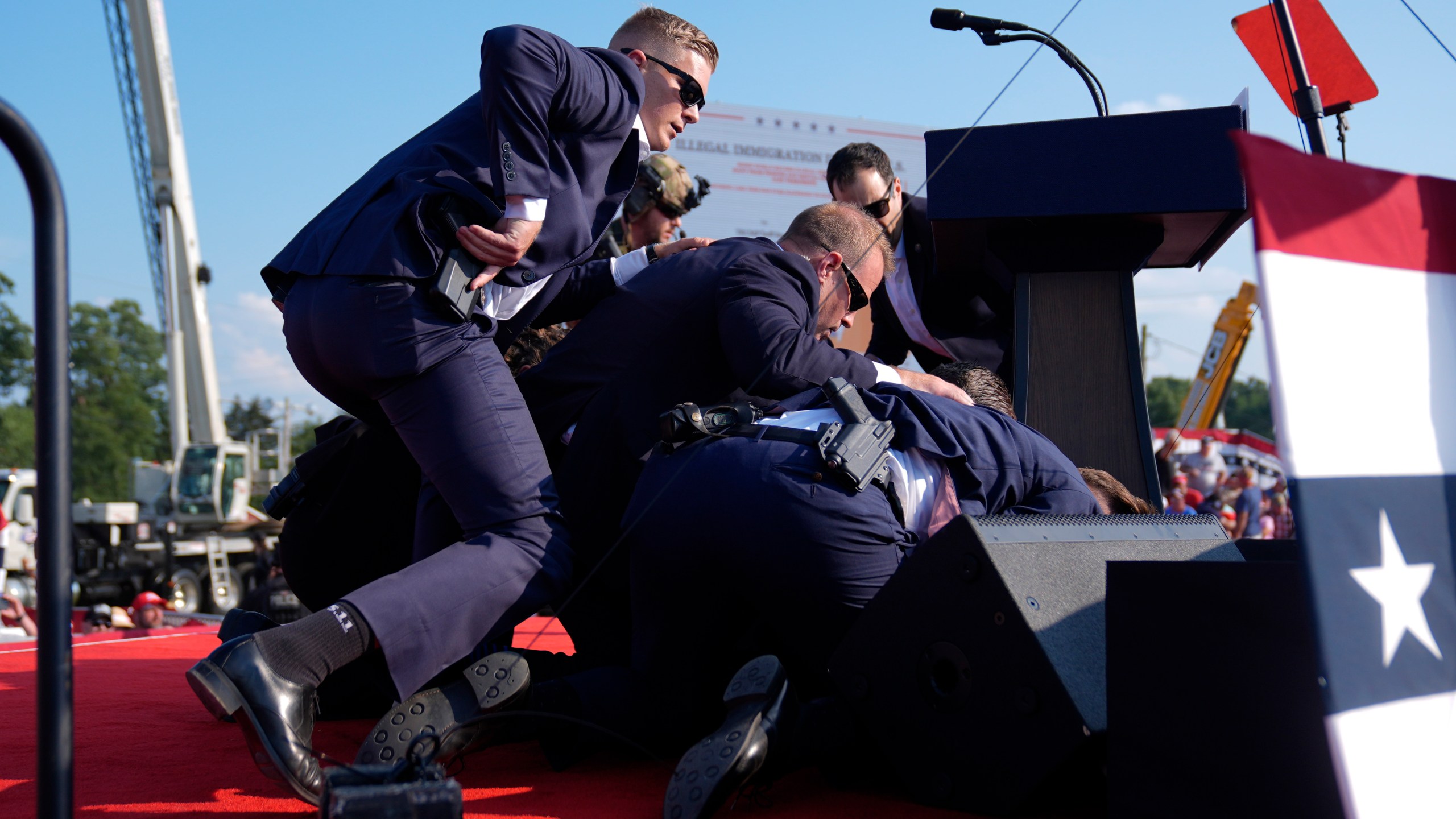 Republican presidential candidate former President Donald Trump is covered by U.S. Secret Service agents at a campaign rally, Saturday, July 13, 2024, in Butler, Pa. (AP Photo/Evan Vucci)