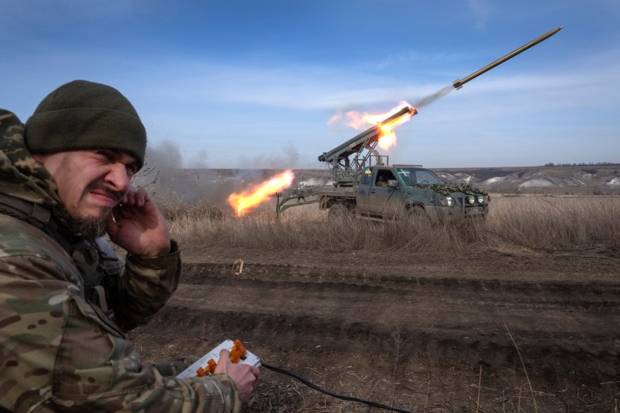 A Ukrainian officer with the 56th Separate Motorized Infantry Mariupol Brigade fires rockets from a pickup truck at Russian positions on the front line near Bakhmut in Ukraine's Donetsk region on March 5, 2024. Ukraine faces twin challenges of fighting Russia and the shifting political sands in the US. (AP Photo/Efrem Lukatsky)