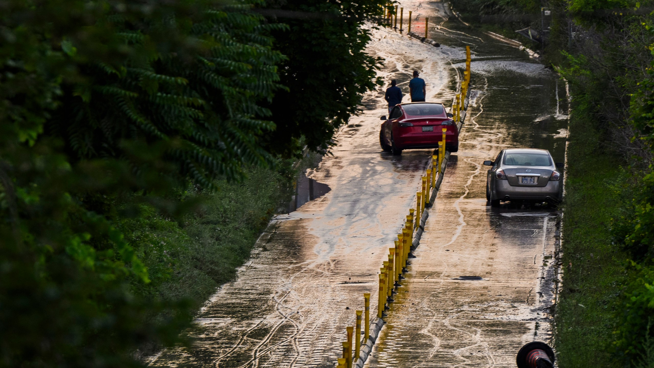 Cars remain stranded on Bayview Avenue as water recedes following heavy rain that caused flooding in Toronto on Tuesday, July 16, 2024. (Christopher Katsarov/The Canadian Press via AP)