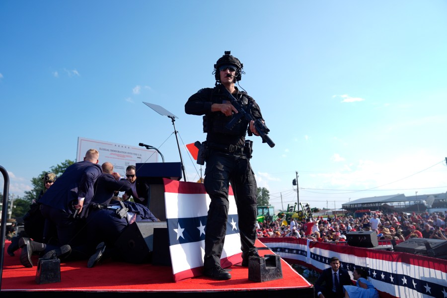 Republican presidential candidate former President Donald Trump is surrounded by U.S. Secret Service agents on stage at a campaign rally, Saturday, July 13, 2024, in Butler, Pa. (AP Photo/Evan Vucci)