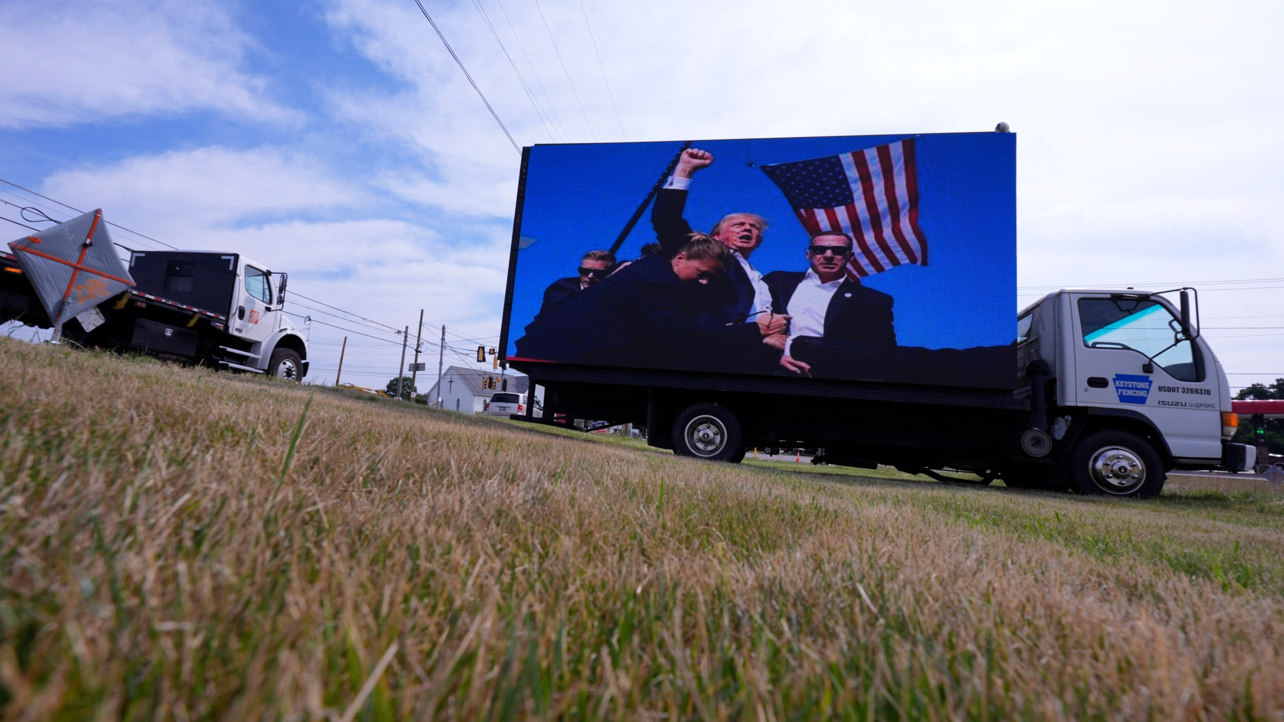 An electronic billboard displays images of former President Donald Trump from his recent rally at the Butler Farm Show, Thursday, July 18, 2024, in Butler, Pa. (AP Photo/Eric Gay)