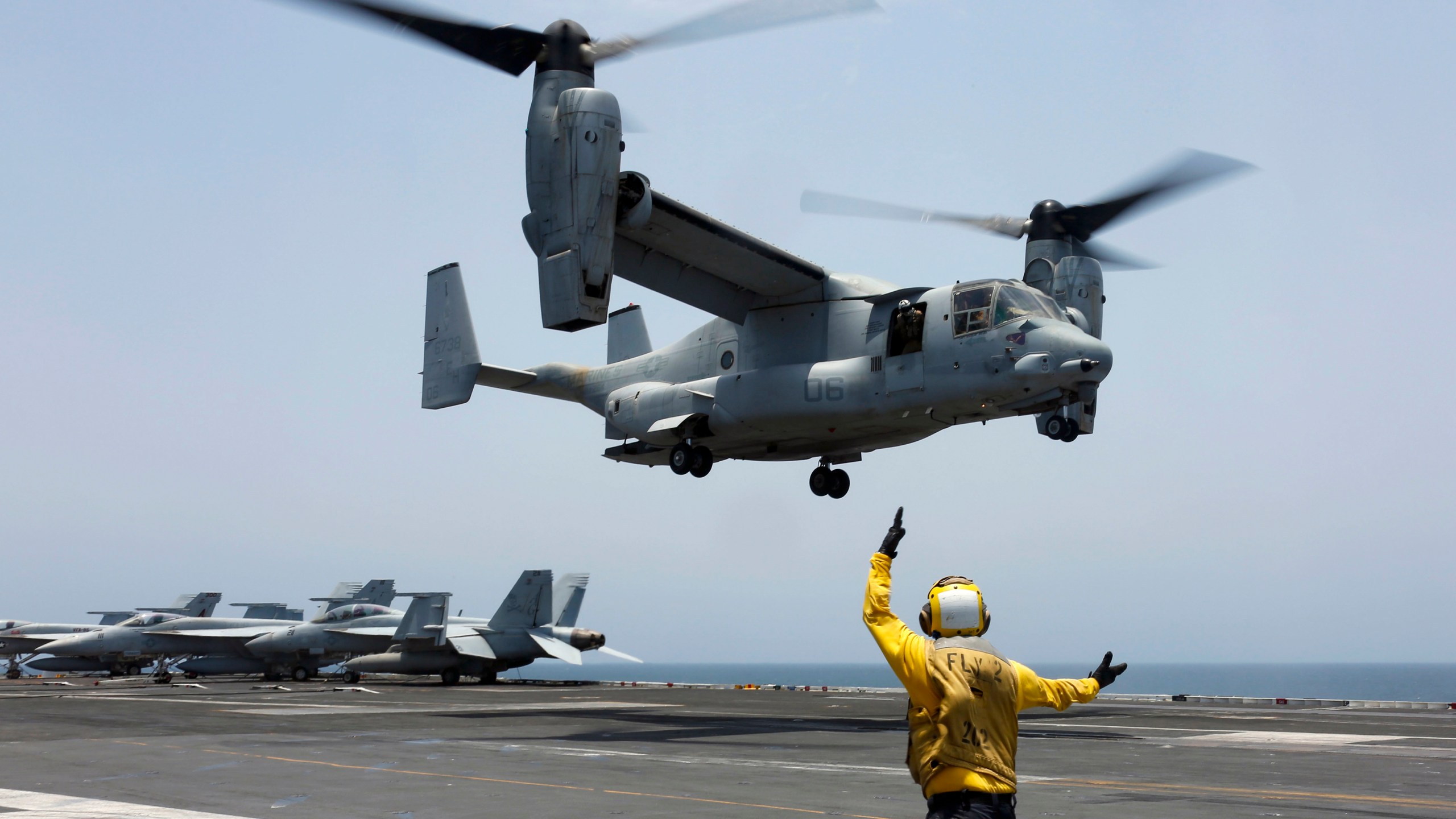 FILE - In this image provided by the U.S. Navy, Aviation Boatswain's Mate 2nd Class Nicholas Hawkins signals an MV-22 Osprey to land on the flight deck of the USS Abraham Lincoln in the Arabian Sea on May 17, 2019. Three Massachusetts lawmakers are pressing Defense Secretary Lloyd Austin to extend flight restrictions on the V-22 Osprey until the military can identify the root causes of multiple recent accidents. Democratic Sens. Elizabeth Warren and Ed Markey and Rep. Lloyd Neal in a letter to Austin on Thursday call the decision to return Ospreys to limited flight status misguided. (Mass Communication Specialist 3rd Class Amber Smalley/U.S. Navy via AP)