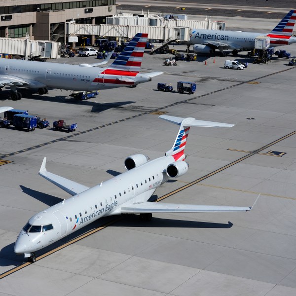 FILE - American Airlines planes wait at gates at Phoenix Sky Harbor International Airport Friday, July 19, 2024, in Phoenix. American Airlines and the union representing its flight attendants said they have reached agreement on a new contract Friday. (AP Photo/Ross D. Franklin, File)