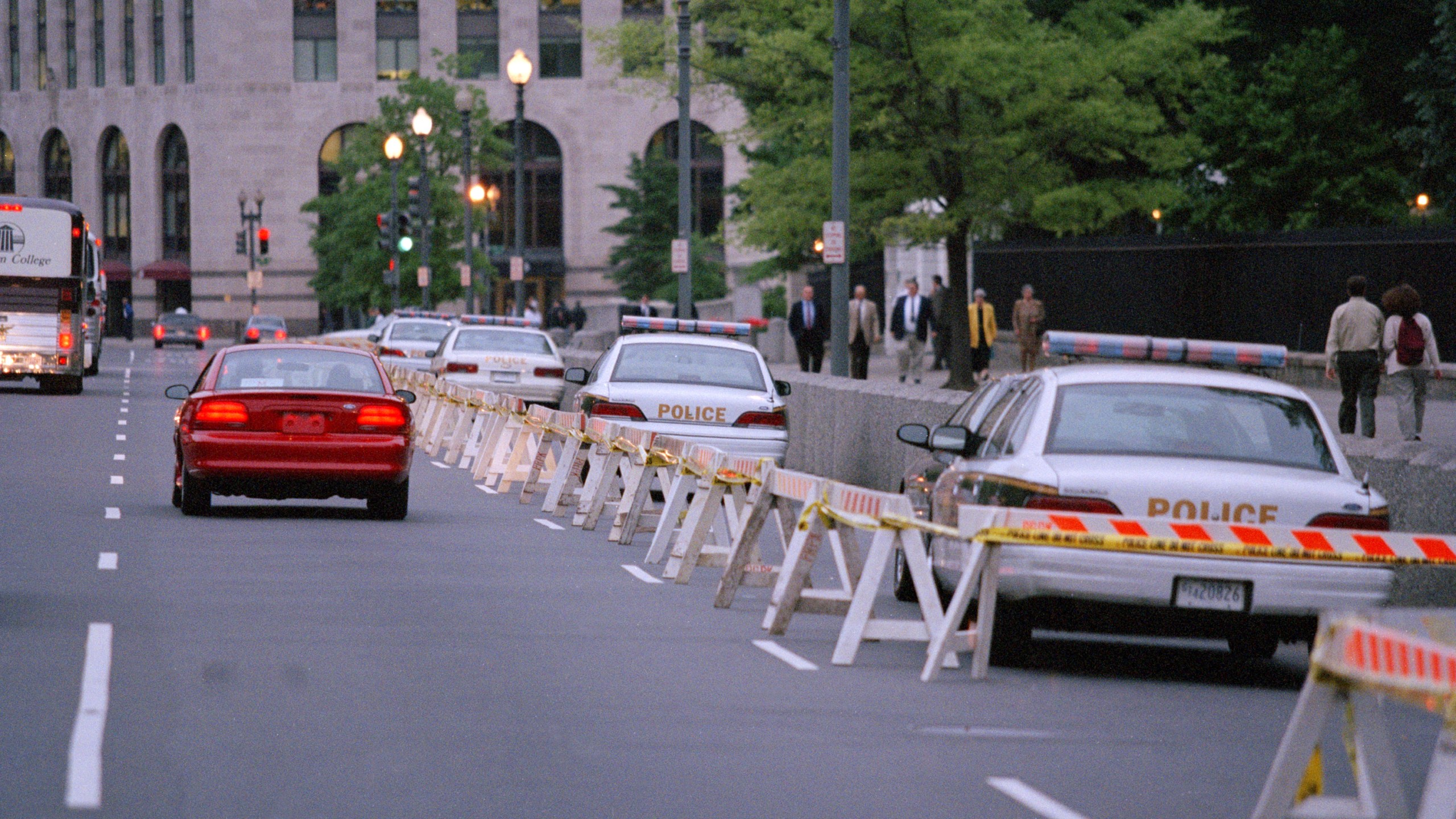 FILE - Cars and buses move along the lane of traffic on Pennsylvania Avenue near the White House in Washington, May 9, 1995, in the most visible tightening of presidential security since the Oklahoma City bombing. Protective details have grown in size, responsibility and technology over more than a century of the Secret Service protecting presidents. When the commander in chief leaves the White House, they're accompanied by a phalanx of Secret Service officers and agents. (AP Photo/Mark Wilson, File)