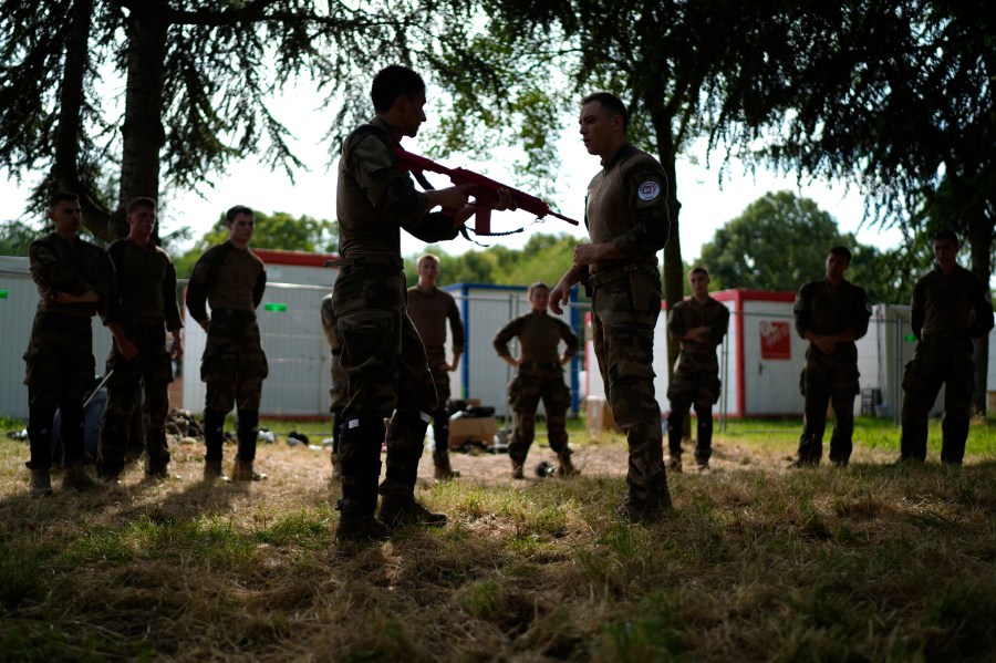 Soldiers demonstrate operational technics for close combat in a training class at a military camp set up for the Paris Olympic games Friday, July 19, 2024, Vincennes, just outside Paris, France. (AP Photo/David Goldman)