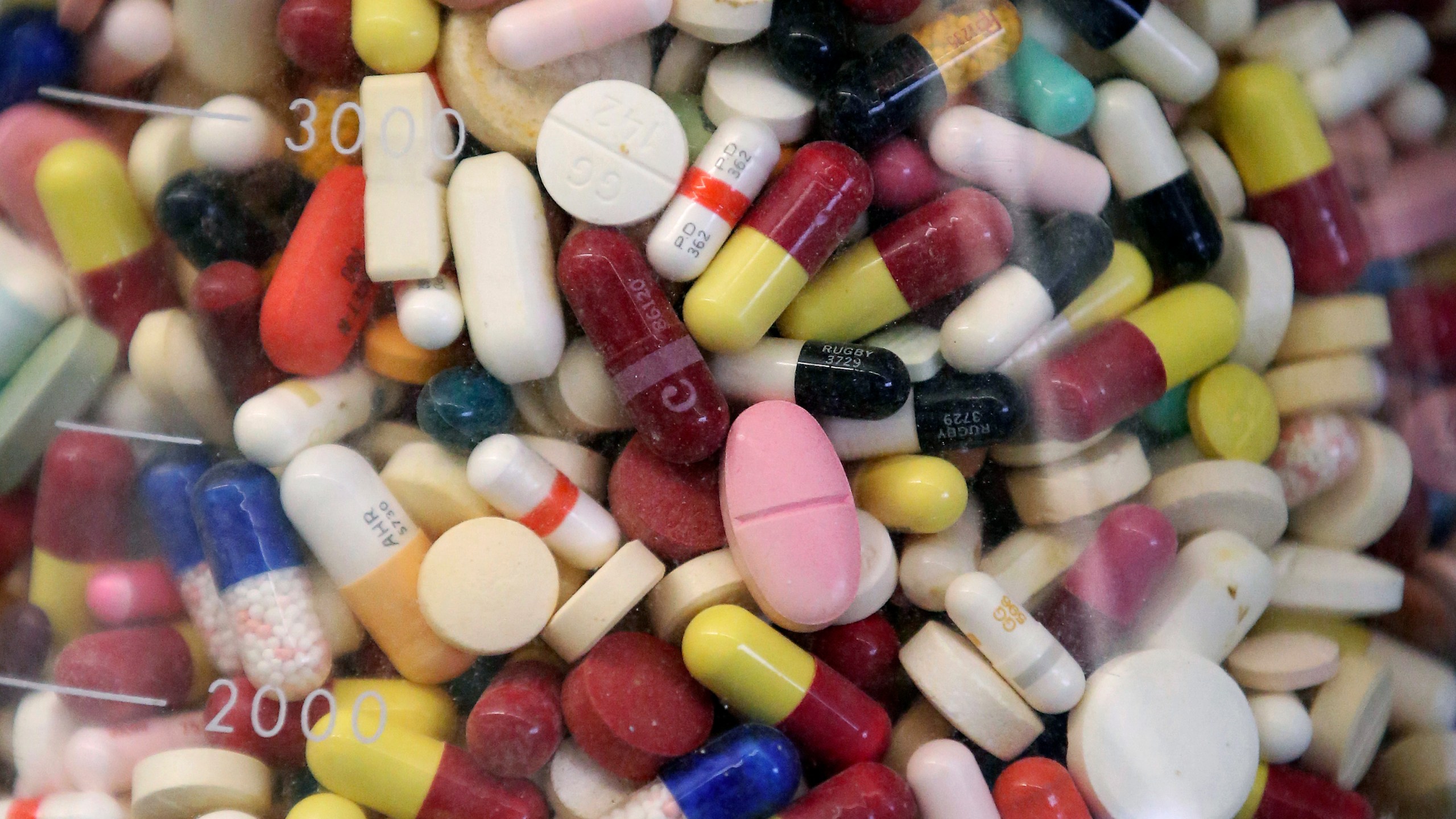 FILE - Prescription drugs are seen in a glass flask at a state laboratory in Taylorsville, Utah, on July 6, 2017. (AP Photo/Rick Bowmer, File)