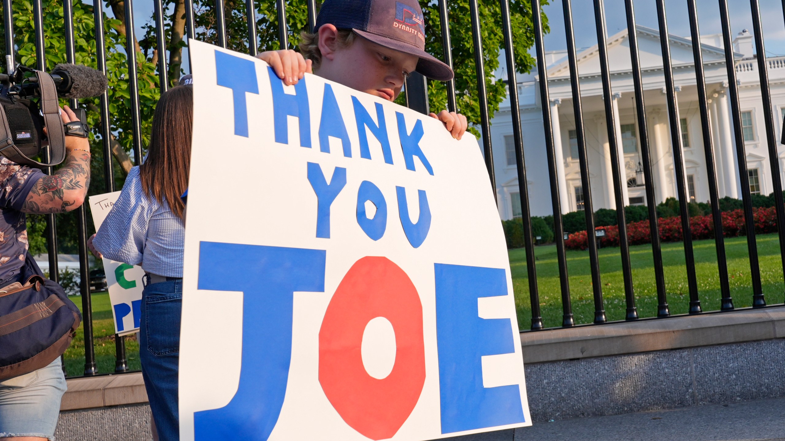 Hugh Kieve, 10, of Washington, holds a sign outside the White House in Washington, Sunday, July 21, 2024, as he and his family come out to show support for President Joe Biden. Biden dropped out of the 2024 race for the White House on Sunday, ending his bid for reelection following a disastrous debate with Donald Trump that raised doubts about his fitness for office just four months before the election. (AP Photo/Susan Walsh)