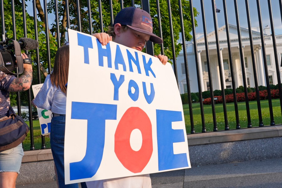 Hugh Kieve, 10, of Washington, holds a sign outside the White House in Washington, Sunday, July 21, 2024, as he and his family come out to show support for President Joe Biden. Biden dropped out of the 2024 race for the White House on Sunday, ending his bid for reelection following a disastrous debate with Donald Trump that raised doubts about his fitness for office just four months before the election. (AP Photo/Susan Walsh)