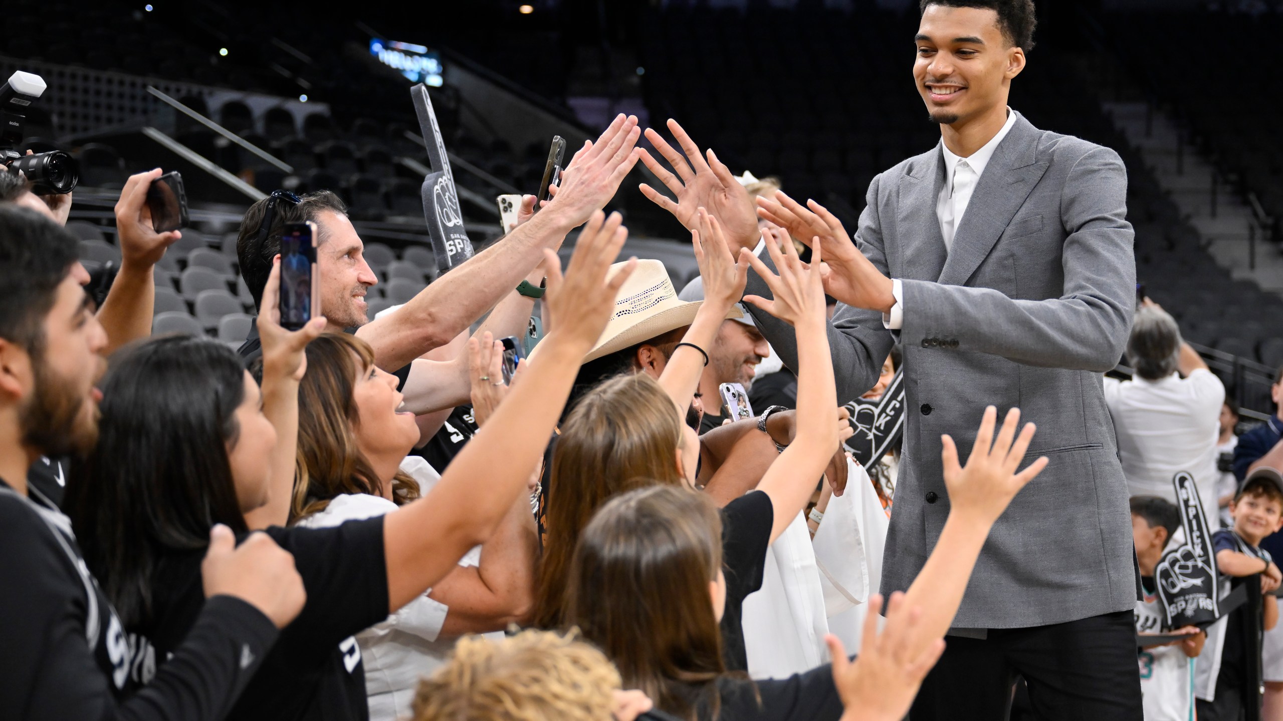 FILE - San Antonio Spurs' Victor Wembanyama, the No. 1 draft pick, greets fans before an NBA basketball press conference, Saturday, June 24, 2023, at the AT&T Center in San Antonio. (AP Photo/Darren Abate, File)