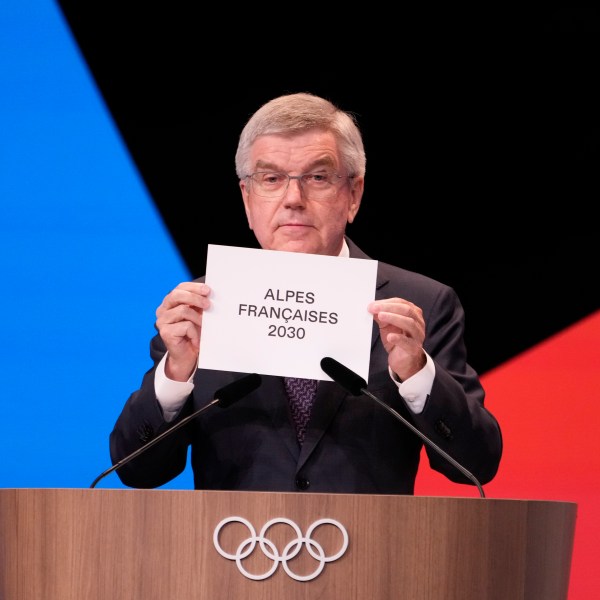 IOC president Thomas Bach announces that the French Alps was named as the 2030 Winter Games host at the 2024 Summer Olympics, Wednesday, July 24, 2024, in Paris, France. The French Alps was named as the 2030 Winter Games host by the International Olympic committee on Wednesday, though with conditions attached. (AP Photo/David Goldman)