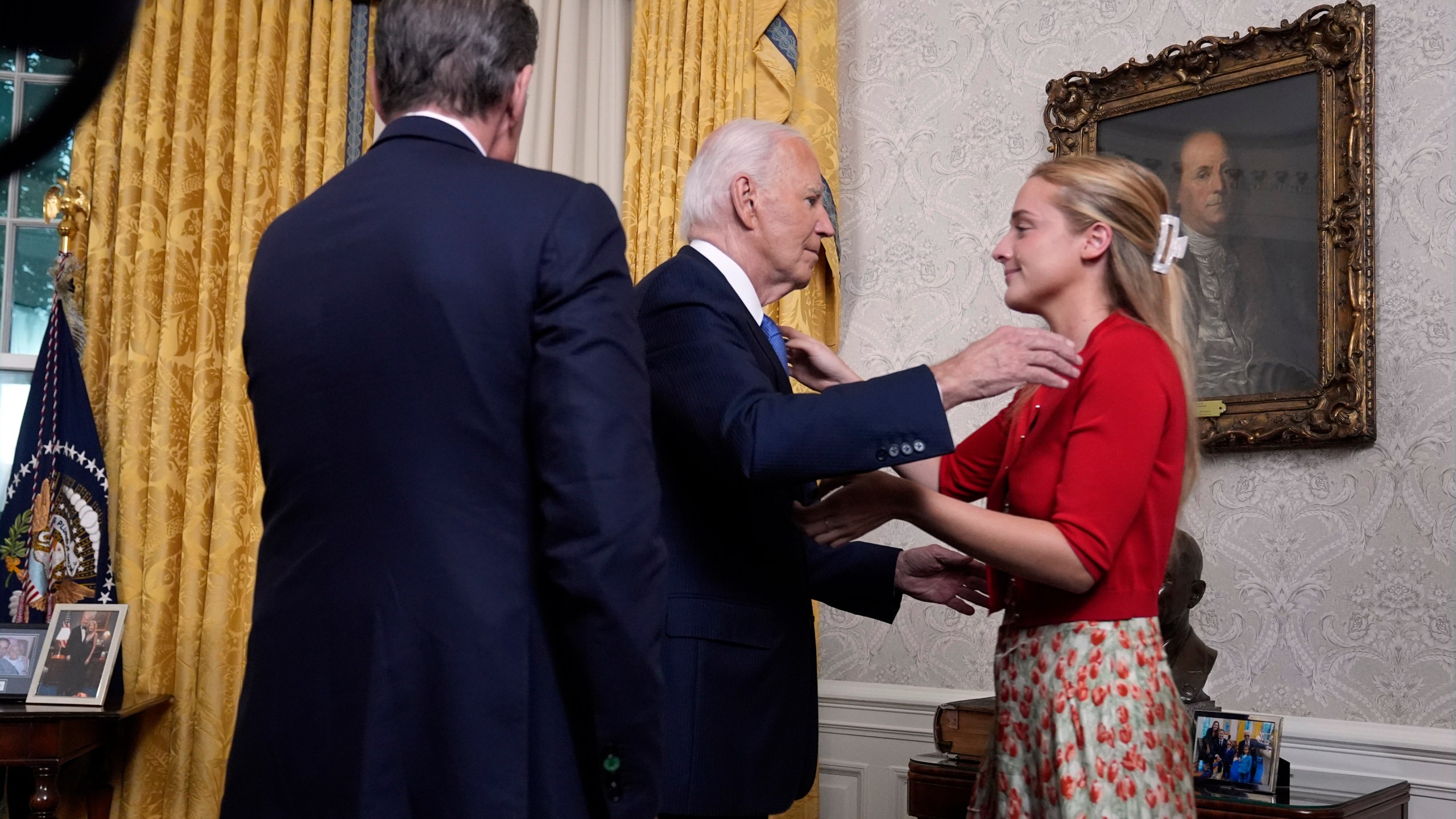 President Joe Biden hugs his granddaughter Finnegan Biden as Hunter Biden watches after addressing the nation from the Oval Office of the White House in Washington, Wednesday, July 24, 2024, about his decision to drop his Democratic presidential reelection bid. (AP Photo/Evan Vucci, Pool)